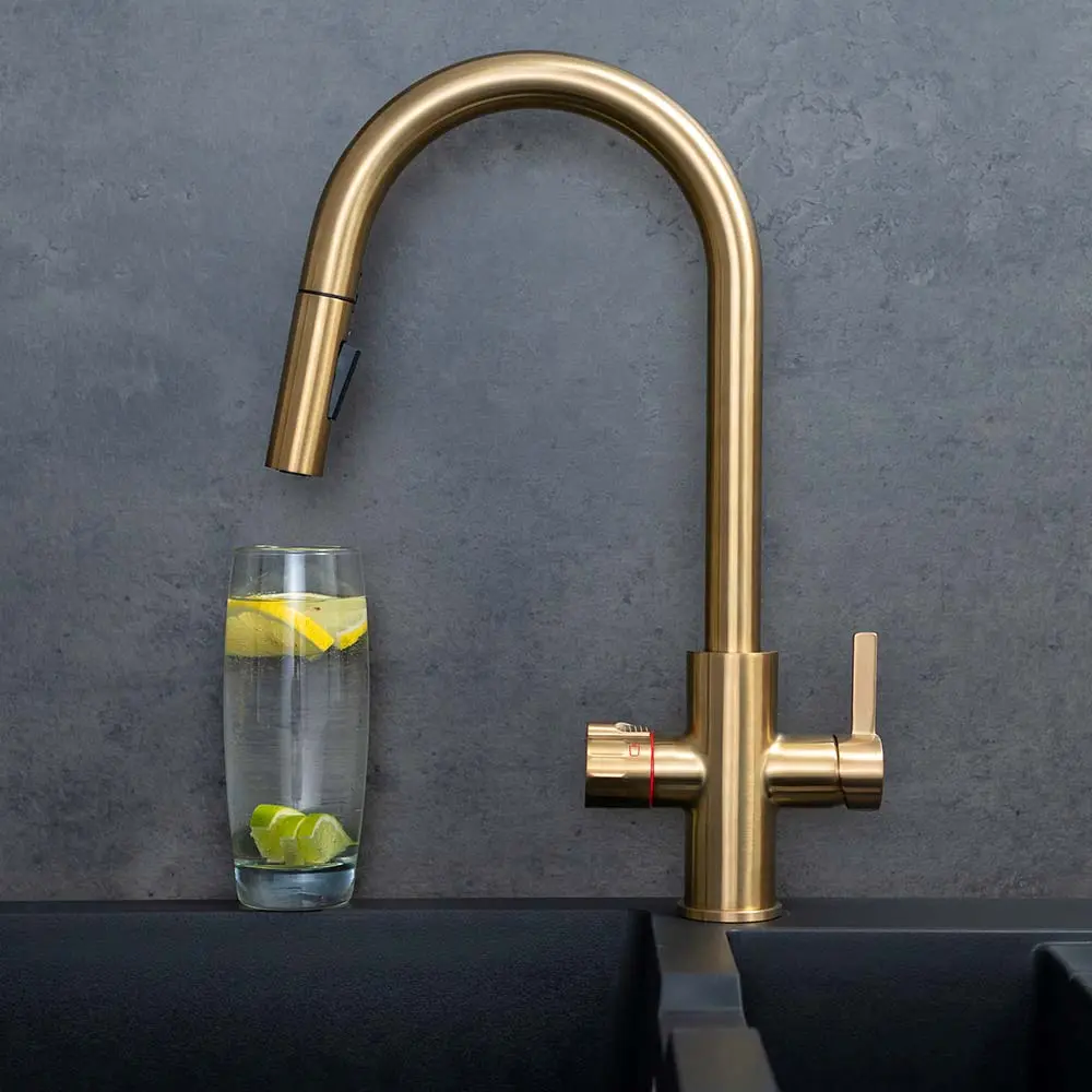 Quel Ultra boiling water tap with pull out spray, with a glass of water beneath the nozzle